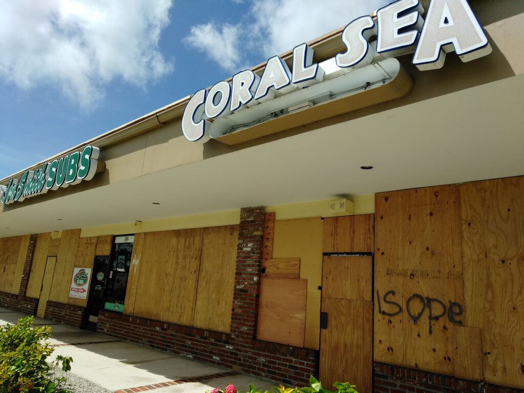 Local fish shop Coral Sea Aquarium in West Palm Beach, FL, bordered up, where brand new owner James Wood camped out for days in the aftermath of Hurricane Irma. Learn more about their story at the end of Part II of our three part series. Image Credit: Coral Sea Aquarium