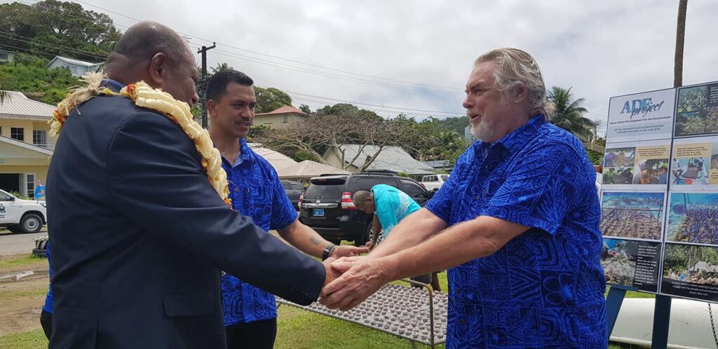 Forestry Minister Naiquamu (left) and Permanent Secretary of Fisheries Pene N. Baleinabuli (center) congratulate Walt Smith (right) of the A.D.E. Project, which will execute the plan to plant out one million new maricultured corals onto Fiji's reefs.