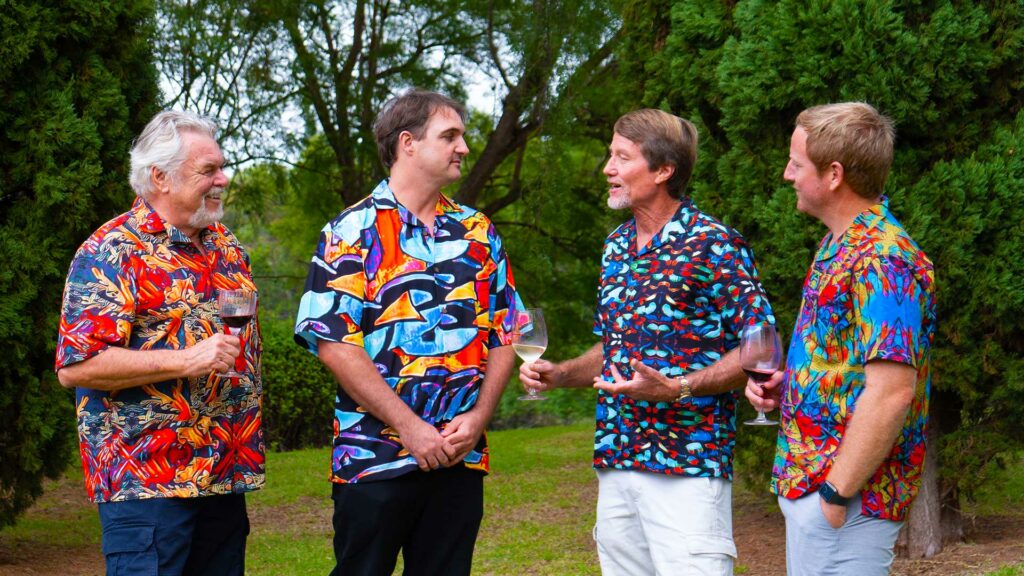 Walt Smith (left) and family members Shawn, Eric, and Carter, model four examples of Smith's expansive new line of aquatic-inspired designs during a recent family gathering in Maui, Hawaii.