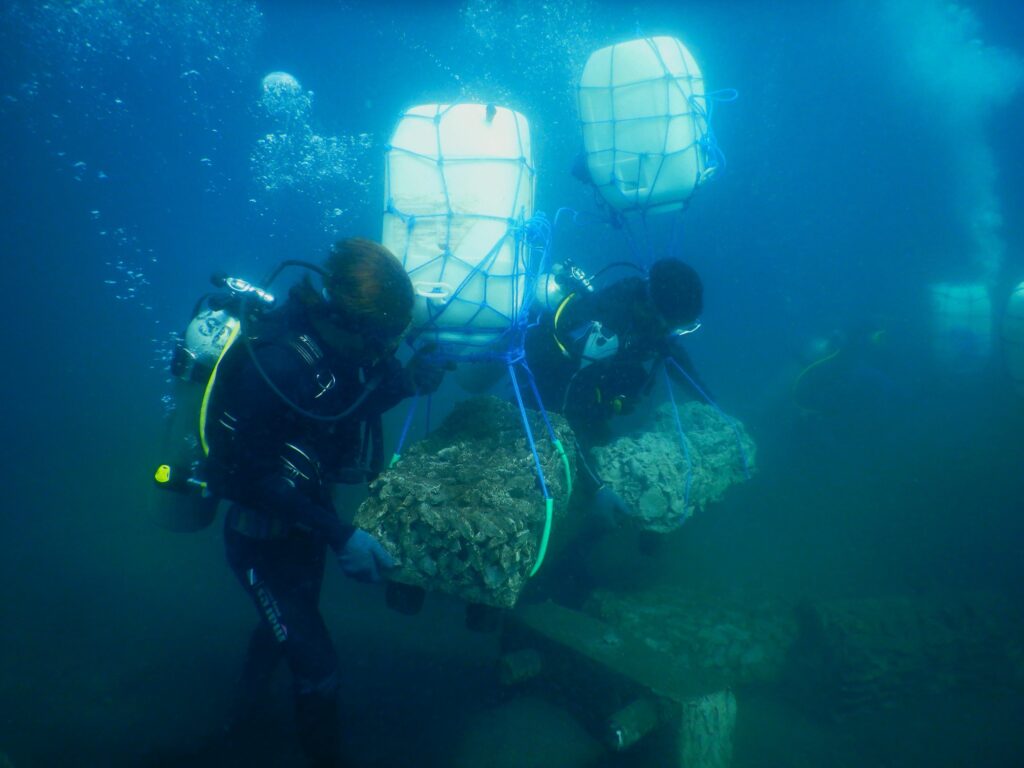 Fishers use air-filled carboys to help them float and transport artificial reef structures to their final placement site on the reefs. Photo courtesy of LINI.