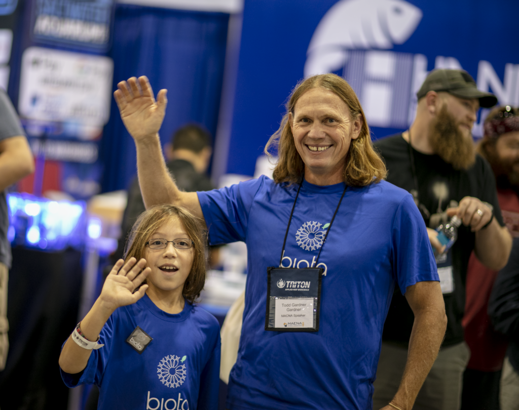 Finn (left) and Todd Gardner offer a smile and a wave at a recent MACNA...fare thee well and thank you to all MASNA volunteers past and present. May our paths continue to converge in the future. Image courtesy MASNA.