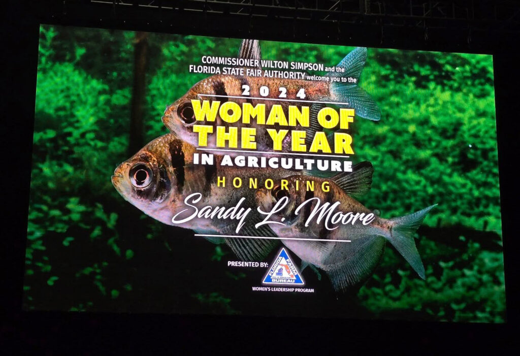 Beautiful, expansive signage honoring Moore was on display throughout the event. Image credit: Roy Yanong.